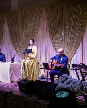 Amrita Kaur sings with the rest of the live musicians