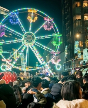 It is a festive atmosphere with a giant wheel 