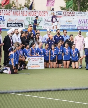 Female athletes adorned with medals 