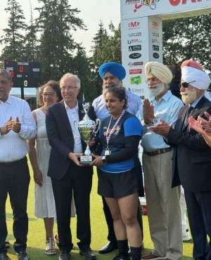 BC Conservative party leader John Rustad presents trophy to a young athlete