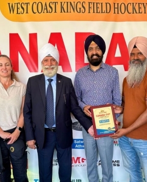 General Secretary of West Coast Kings Field Hockey Club Udham Singh Hundal, Khalsa Credit Union's Tochi Sandhu presents plaque to President of West Coast Kings Field Hockey Club Jassy Mangat 