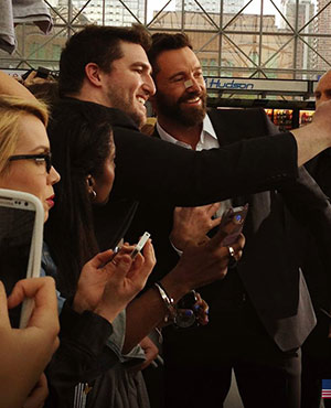 Hugh poses for selfie with a fan